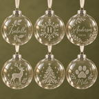 Six personalised glass Christmas baubles with six different engraving designs