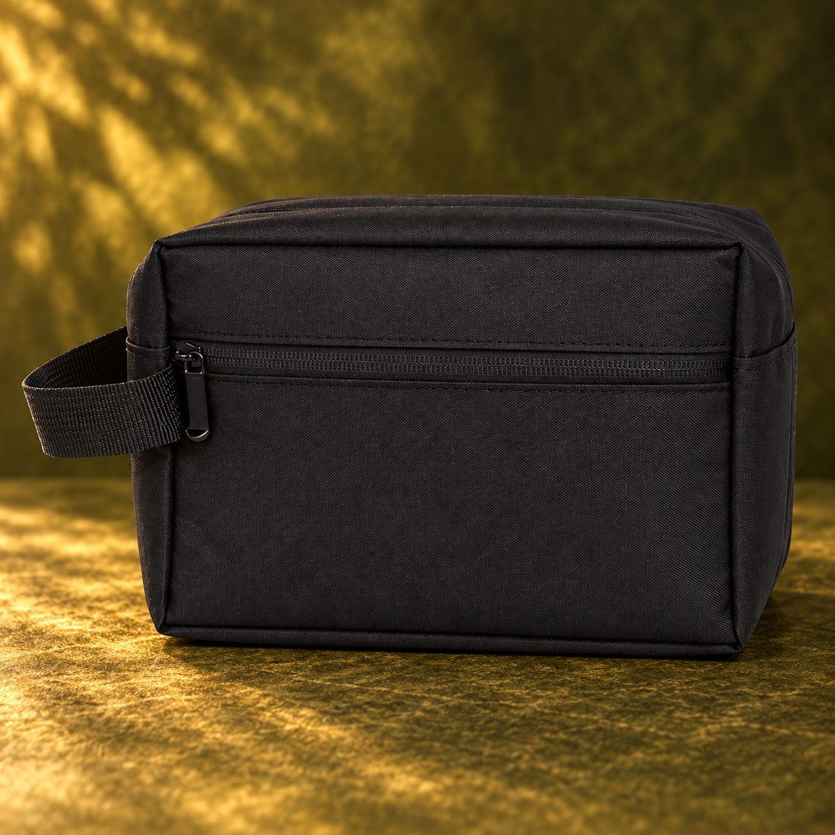 Plain black polyester toiletry bag on olive green background