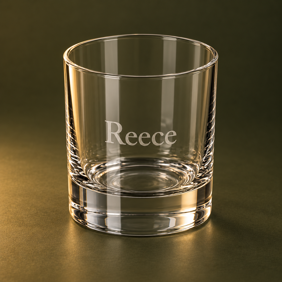 Side angle of engraved 245 ml whiskey tumbler on olive background